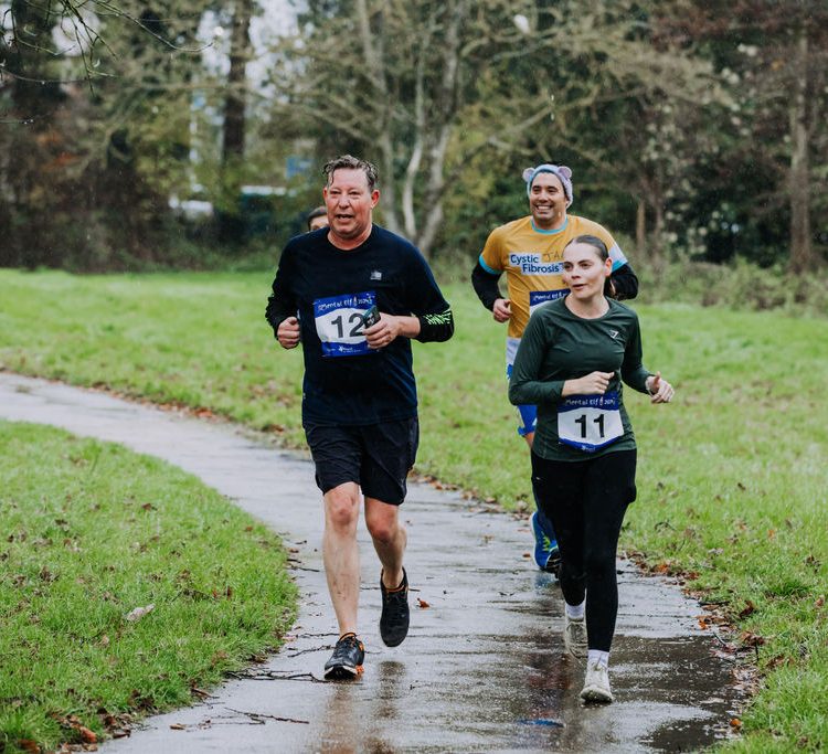 Group of runners coming around a bend