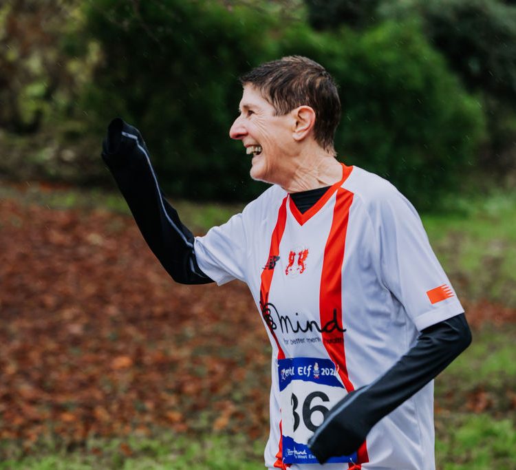 A runner waves to someone off camera