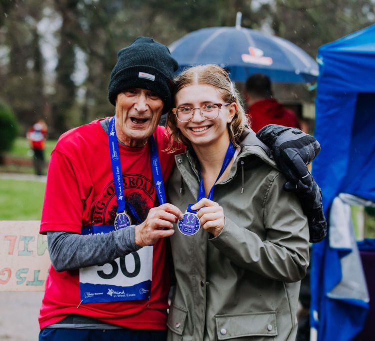Man and young woman pose with their medals