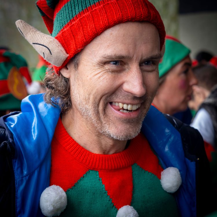 Close up shot of man in elf jumper and hat