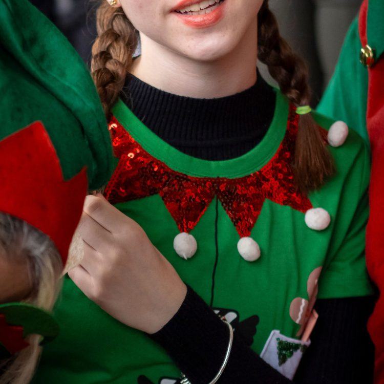 A young girl in elf costume looking at the camera