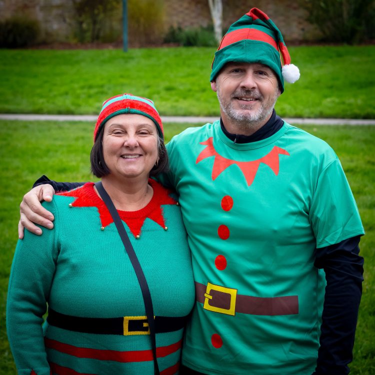 Man with arm around woman as they pose for the camera