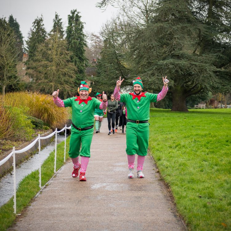 Two men in matching elf outfits