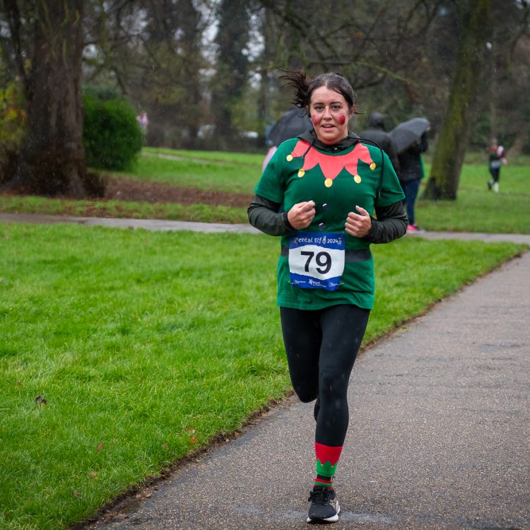 Runner in elf top and socks looking at the camera