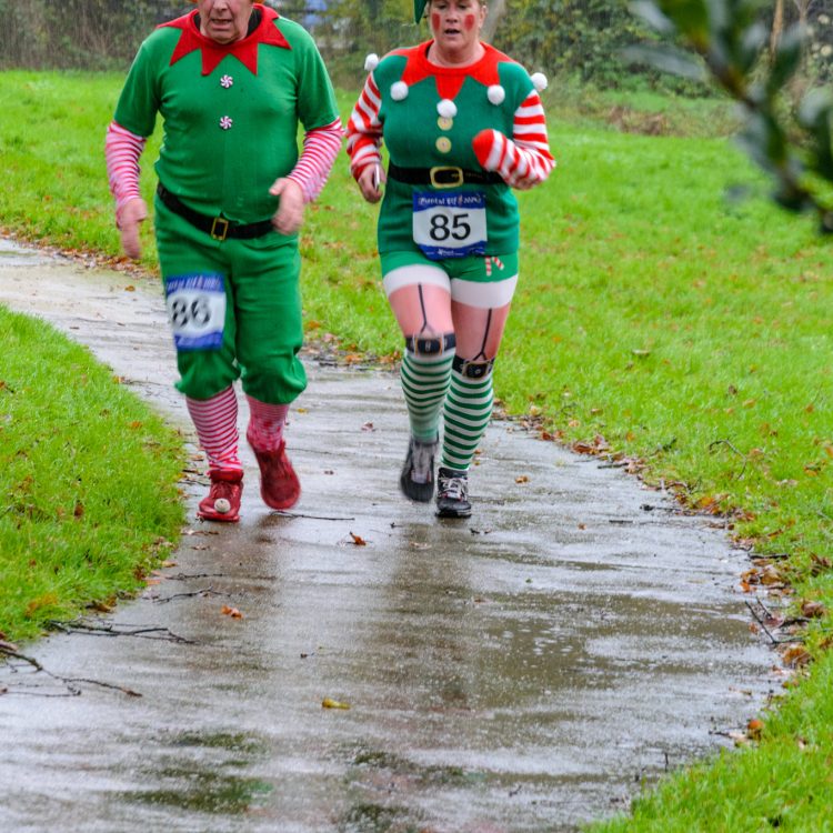 Man and woman dressed as elves running
