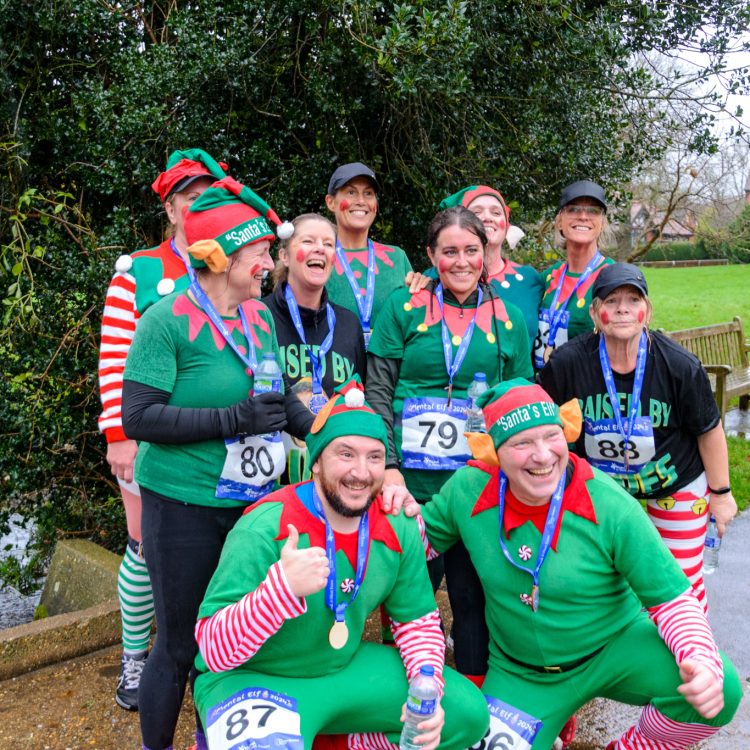 Group of runners dressed as elves with medals