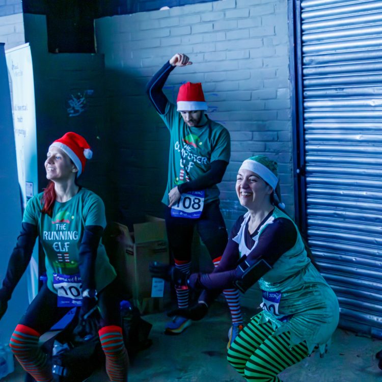People dressed as elves doing squats