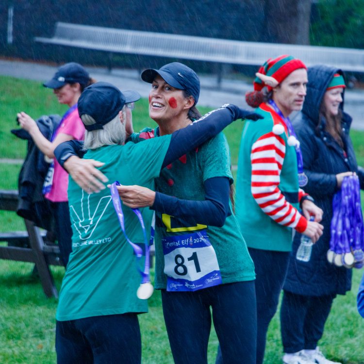 Runners dressed as elves, receiving medals.