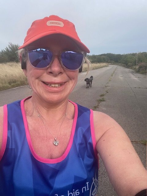 Woman wearing running vest and cap